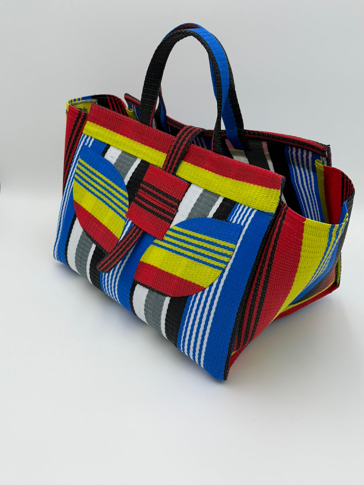 Regal Large handwoven tote bag by SCRUBIES in Red,Yellow,Blue,White,Black with Stripes design and Leaf accent pattern